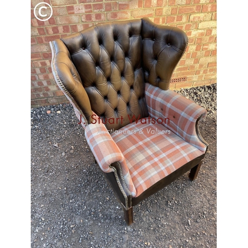 64 - A refurbished brown leather chesterfield wing back chair with tartan pattern wings