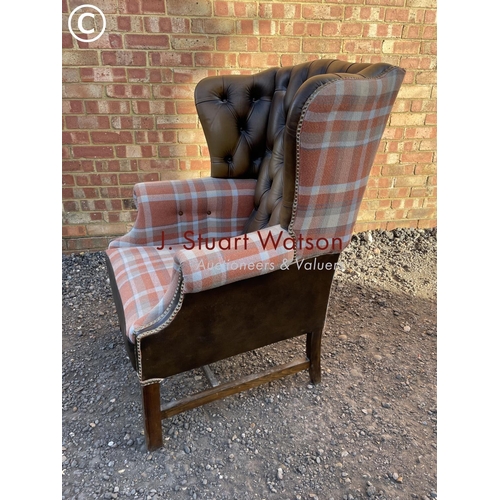 64 - A refurbished brown leather chesterfield wing back chair with tartan pattern wings