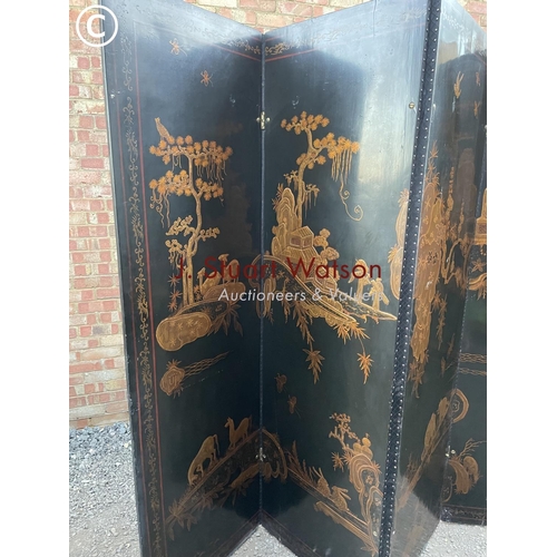 85 - A very large four section oriental folding screen decorated to both sides 220cm high