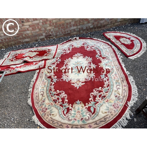 276 - A set of red pattern chinese carpets including very large oval