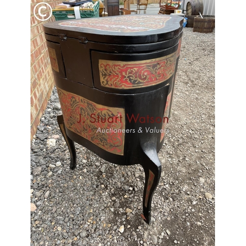 103 - An unusual black laquered vanity chest with fold over top to reveal mirror and leather surface