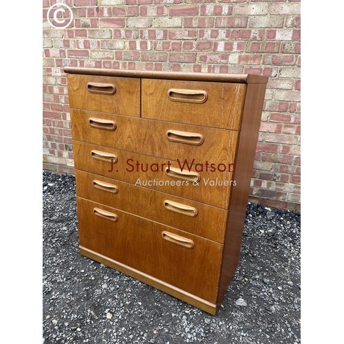 11 - A mid century teak tallboy chest of six drawers