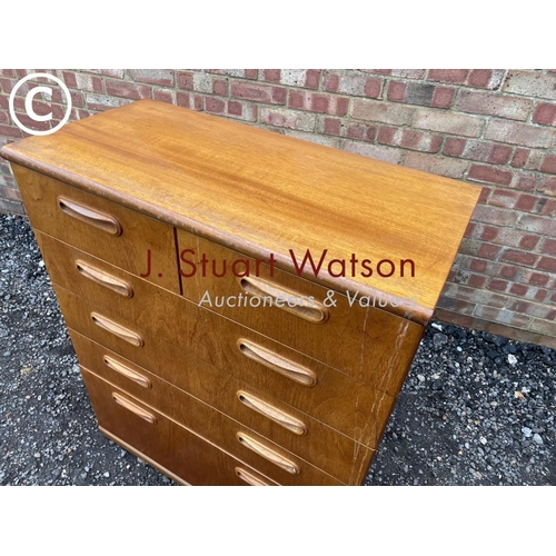 11 - A mid century teak tallboy chest of six drawers