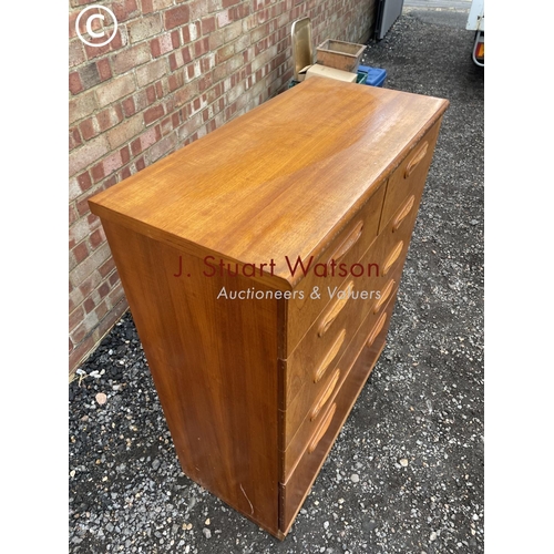 11 - A mid century teak tallboy chest of six drawers