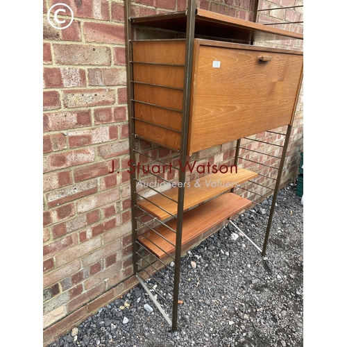 113 - A ladderax home office system with a bureau desk and four shelves. Gold uprights