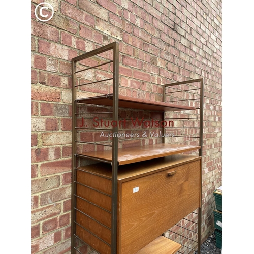 113 - A ladderax home office system with a bureau desk and four shelves. Gold uprights