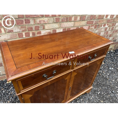 12 - A reproduction yew wood sideboard 90cm wide