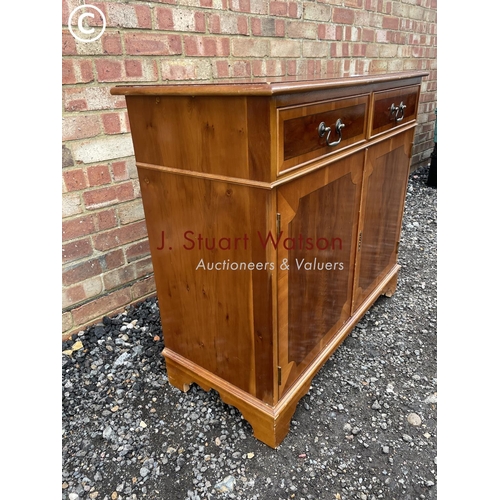 12 - A reproduction yew wood sideboard 90cm wide