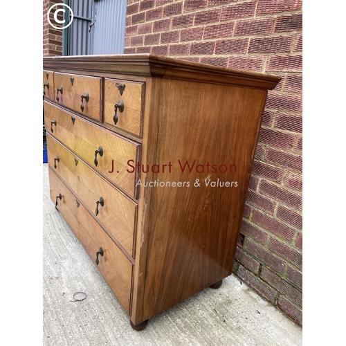 125 - A large continental style fruitwood chest of six drawers fitted with brass drop handles