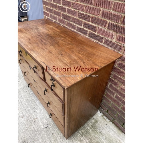 125 - A large continental style fruitwood chest of six drawers fitted with brass drop handles