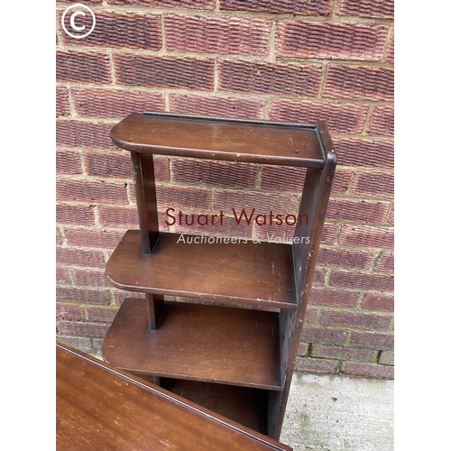 130 - A mahogany nest of two, yew magazine rack and a bookcase