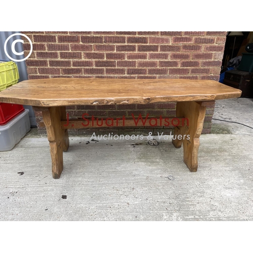 133 - An ecclesiastic style oak log effect table, carved to the base