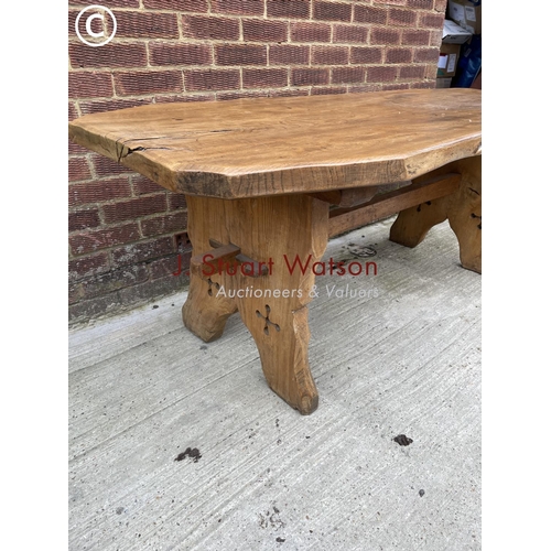 133 - An ecclesiastic style oak log effect table, carved to the base