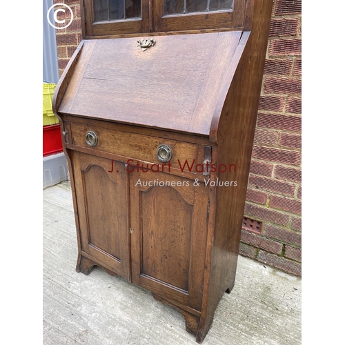 134 - An early  20th century oak bureau bookcase with a leaded glass top