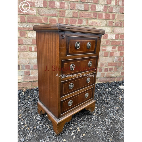 14 - A small reproduction mahogany batchelors chest with red leather fold over top