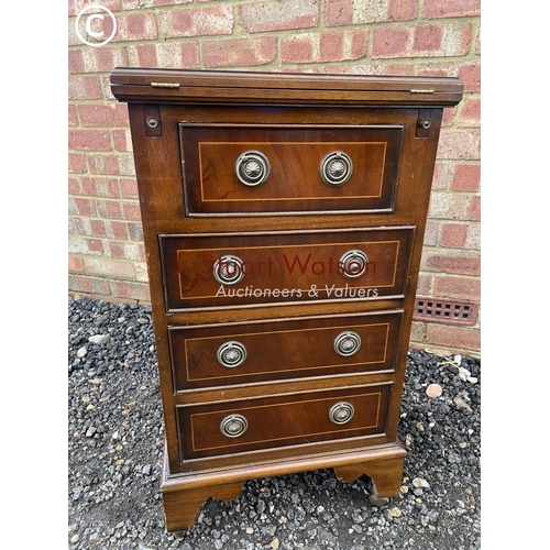 14 - A small reproduction mahogany batchelors chest with red leather fold over top