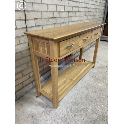 155 - A light oak three drawer hall table