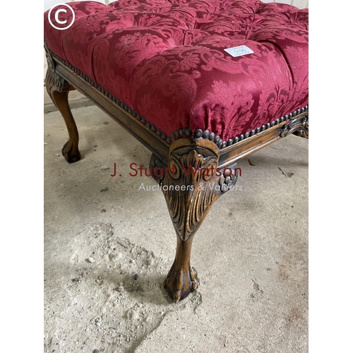 195 - A red upholstered buttoned footstool with ball and claw feet