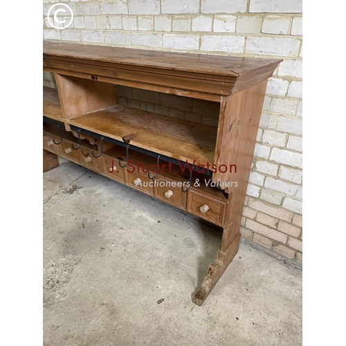 198 - A large farmhouse style pine butchers rack with a row of 8 drawers and a row of metal hooks