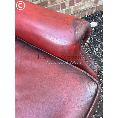 22 - A red leather chesterfield wing back chair