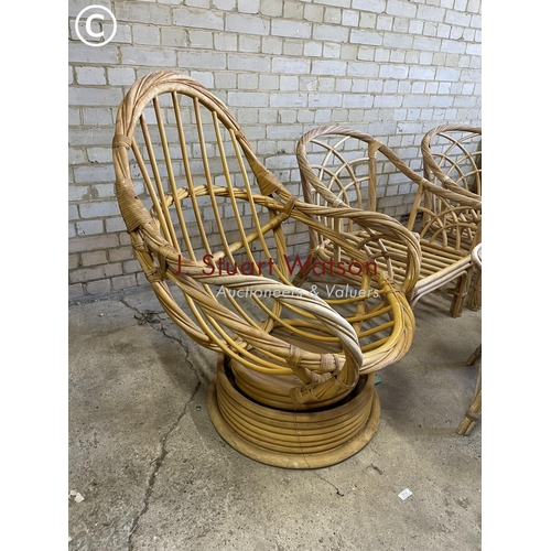 226 - A bamboo swivel egg chair together with a pair of chairs and two tables