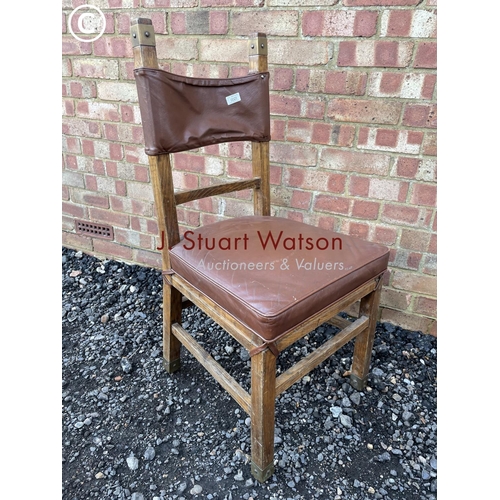 25 - An unusual oak chair with brown leather seat amd brass strapwork