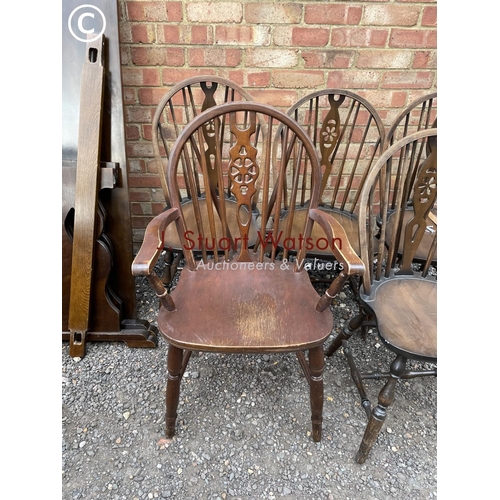 253 - A refectory style oak dining table together with five wheelback chairs including one carver