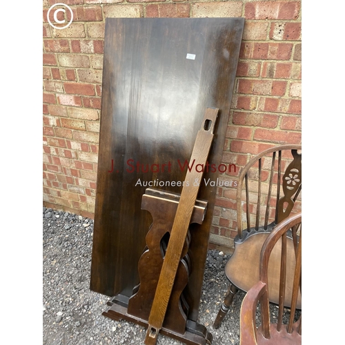 253 - A refectory style oak dining table together with five wheelback chairs including one carver