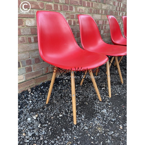 26 - A set of four modern Eames style chairs in red