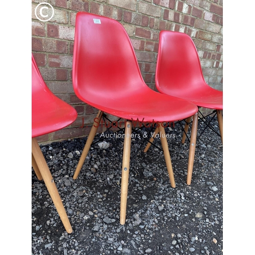 26 - A set of four modern Eames style chairs in red