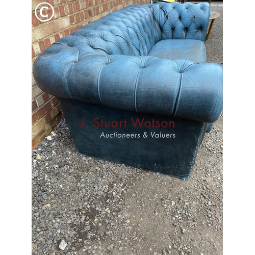 261 - A blue leather chesterfield sofa AF with castors in box