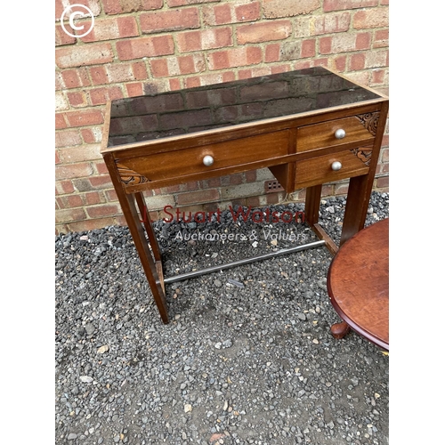 264 - A hardwood three drawer desk together with a mahogany coffee table