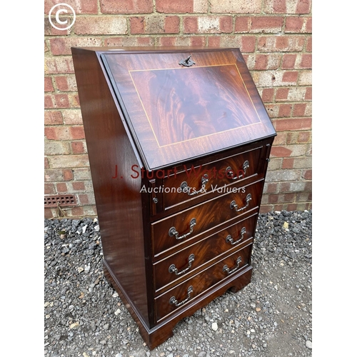 271 - A reproduction mahogany bureau with a fitted interior