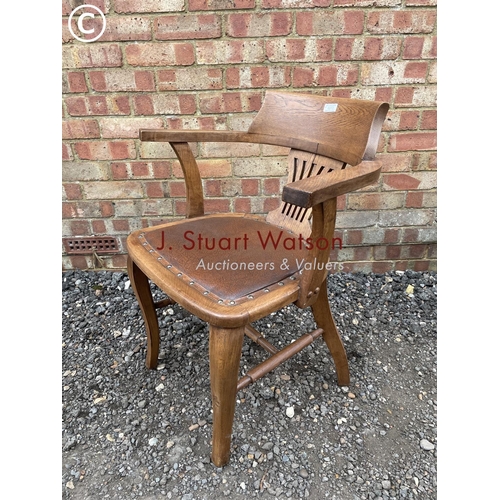 272 - An oak bow back desk chair