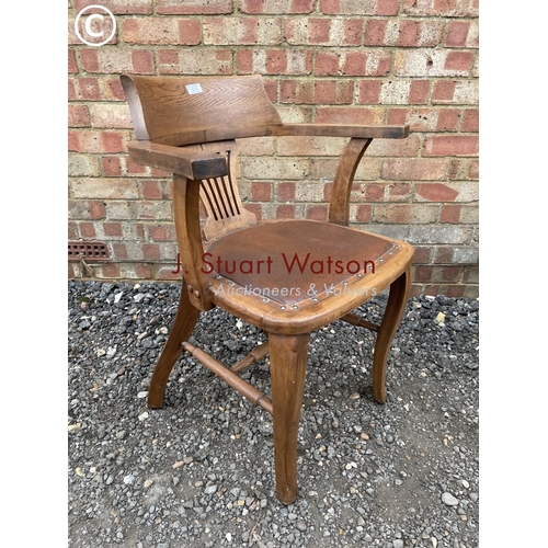 272 - An oak bow back desk chair