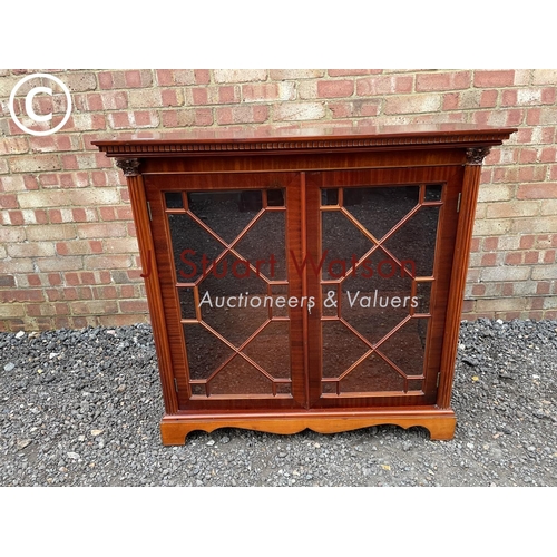 274 - A reproduction yew wood glazed bookcase