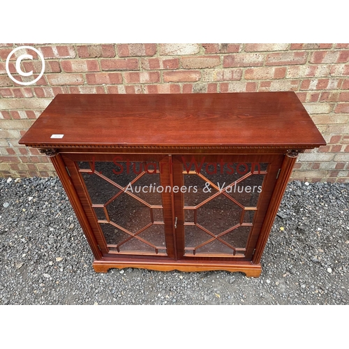 274 - A reproduction yew wood glazed bookcase