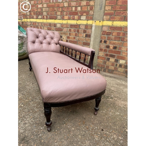 303 - An Edwardian chaise longue upholstered in mauve leather