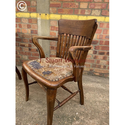 304 - An oak smokers bow back chair together with a mahogany desk chair