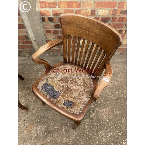 304 - An oak smokers bow back chair together with a mahogany desk chair