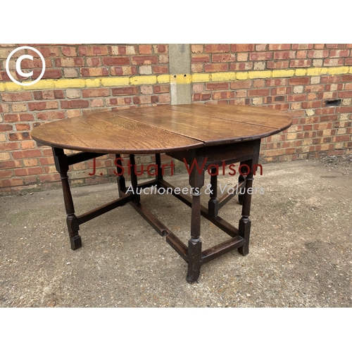 305 - An antique oak gateleg table 140cm diameter