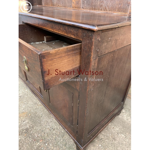 306 - An oak dresser having a plate rack top over two drawers and three cuobaord door base 145x60x195