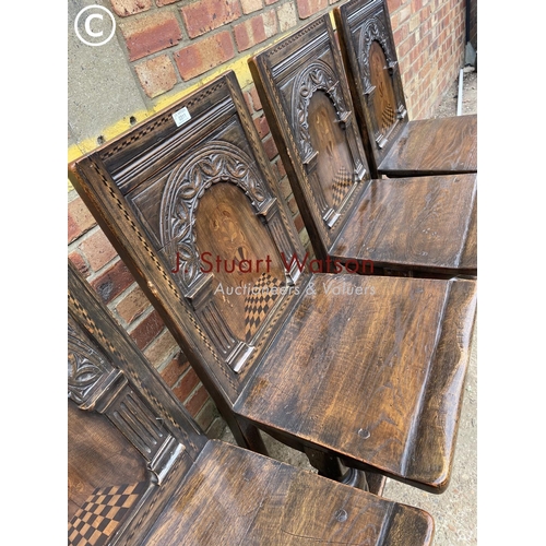 311 - A set of four oak panel back chairs with inlay