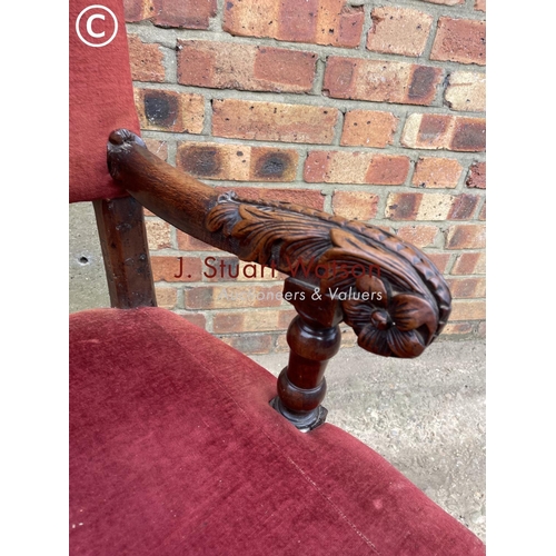 312 - A carved oak 'throne' carver chair with red upholstery