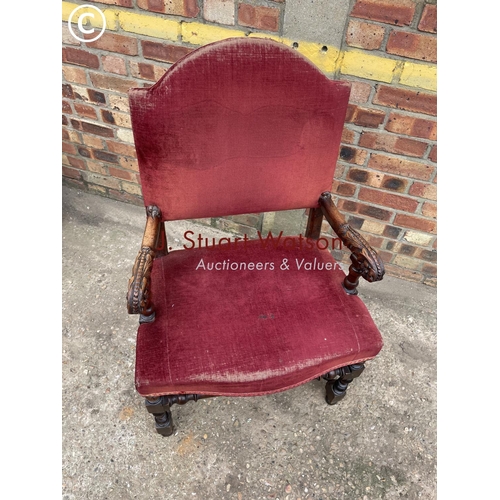 312 - A carved oak 'throne' carver chair with red upholstery