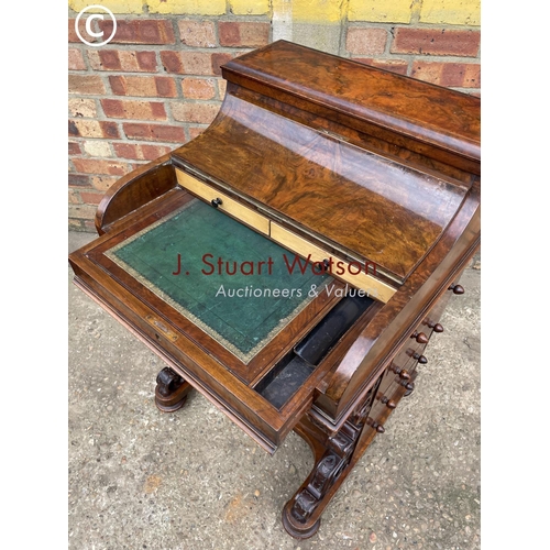 313 - A Victorian walnut pop top davenport with fitted interior and  four drawers and four dummy drawers.