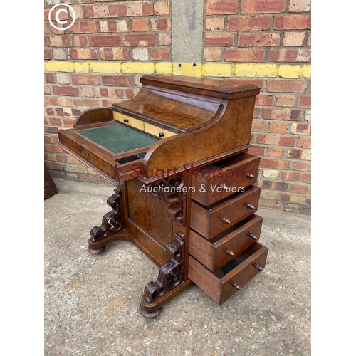 313 - A Victorian walnut pop top davenport with fitted interior and  four drawers and four dummy drawers.