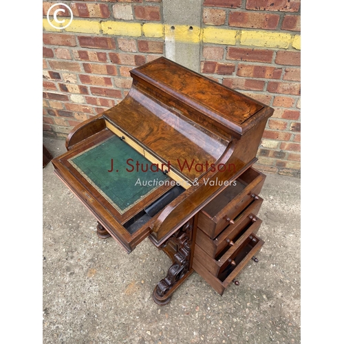 313 - A Victorian walnut pop top davenport with fitted interior and  four drawers and four dummy drawers.