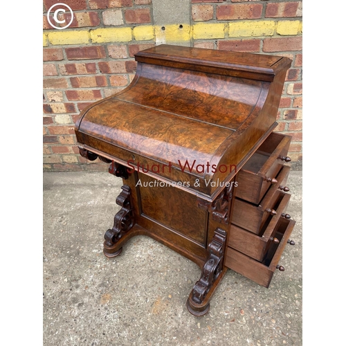 313 - A Victorian walnut pop top davenport with fitted interior and  four drawers and four dummy drawers.