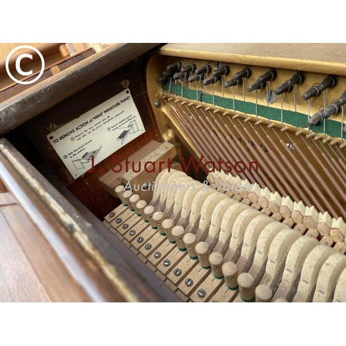 315 - A compact walnut cased Kemble Miniature piano 133wide